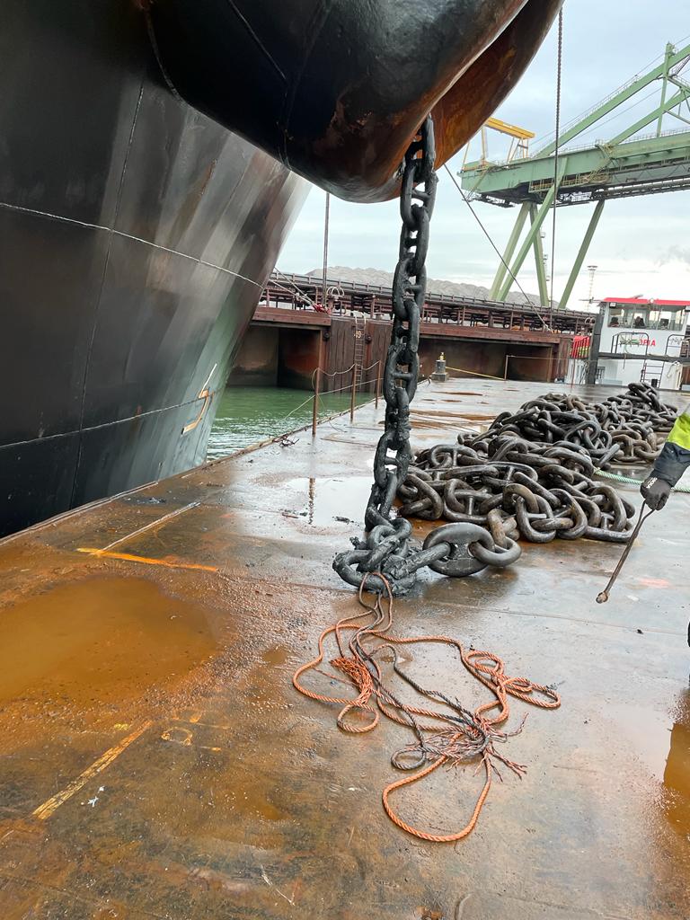 Anchor chain being hoisted into the bulk carriers chain pocket